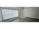 Bright living room boasts lots of natural light and stylish gray wood flooring at 743 Belvoir Dr, Davenport, FL 33837