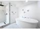 Bathroom featuring a soaking tub, marble floors, and a stand up shower with glass doors at 758 Osceola Dr, Sanford, FL 32773