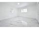 Bright bedroom with updated marble floors, two windows, and white molding throughout the room at 758 Osceola Dr, Sanford, FL 32773
