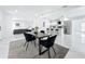 Bright dining room featuring an open layout with a modern table, chairs, and a view of the kitchen at 758 Osceola Dr, Sanford, FL 32773