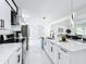 Spacious kitchen featuring stainless steel appliances, white cabinets, and an island with pendant lighting at 758 Osceola Dr, Sanford, FL 32773