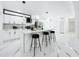 Modern kitchen featuring an island with seating, sleek countertops, and stainless steel appliances at 758 Osceola Dr, Sanford, FL 32773