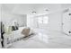 Updated main bedroom featuring a large window, a view of the bathroom, and white marble floors at 758 Osceola Dr, Sanford, FL 32773