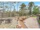 Backyard featuring mature landscaping, a wood fence, and a fire pit at 811 Gatehouse Dr, Winter Springs, FL 32708