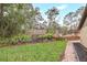 Backyard featuring a well manicured lawn, mature landscaping and a wood fence at 811 Gatehouse Dr, Winter Springs, FL 32708