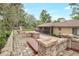Backyard featuring a hot tub, brick columns, and mature landscaping at 811 Gatehouse Dr, Winter Springs, FL 32708