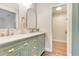 Stylish bathroom featuring a modern vanity with double sinks, gold hardware, and a walk-in closet for ample storage at 811 Gatehouse Dr, Winter Springs, FL 32708
