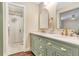 Elegant bathroom features double sinks with modern faucets, white countertop, and glass-enclosed shower at 811 Gatehouse Dr, Winter Springs, FL 32708