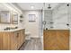 Modern bathroom with a glass enclosed shower, wood grain cabinet and attractive tile flooring at 811 Gatehouse Dr, Winter Springs, FL 32708