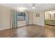 Bright bedroom with vinyl floors, a large window with curtains, and a modern ceiling fan at 811 Gatehouse Dr, Winter Springs, FL 32708