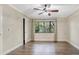 Bright bedroom with hardwood floors, ceiling fan, a large window offering views, and neutral walls at 811 Gatehouse Dr, Winter Springs, FL 32708
