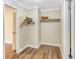 Cozy walk-in closet featuring hardwood floors, neutral walls, shelving, and a hanging rod at 811 Gatehouse Dr, Winter Springs, FL 32708