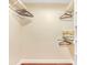 Organized walk-in closet with neutral tones, shelves, hanging rods, and a decorative pillow at 811 Gatehouse Dr, Winter Springs, FL 32708