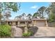 Charming single-story home with a well-manicured lawn, lovely landscaping, and a welcoming entrance at 811 Gatehouse Dr, Winter Springs, FL 32708