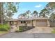 Ranch-style home featuring a well-maintained yard, two car garage, and a charming front walkway with a pergola at 811 Gatehouse Dr, Winter Springs, FL 32708