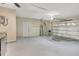 Spacious garage with neutral paint, painted floors, shelving, and an automatic door at 811 Gatehouse Dr, Winter Springs, FL 32708