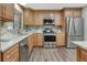 This bright kitchen offers stainless steel appliances, stone countertops, backsplash, and ample storage space at 811 Gatehouse Dr, Winter Springs, FL 32708