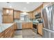 Well-equipped kitchen showcases ample cabinetry, modern appliances, stone countertops, and backsplash at 811 Gatehouse Dr, Winter Springs, FL 32708