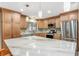 Spacious kitchen featuring custom cabinets, granite countertops, stainless steel appliances, and pendant lighting at 811 Gatehouse Dr, Winter Springs, FL 32708
