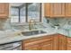 Kitchen features stone countertops and backsplash, stainless steel appliances, and a modern gold faucet at 811 Gatehouse Dr, Winter Springs, FL 32708