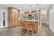 Gourmet kitchen boasts custom cabinets, stainless steel appliances, a center island, and modern pendant lighting at 811 Gatehouse Dr, Winter Springs, FL 32708
