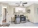 Clean laundry room featuring stainless steel washer and dryer, overhead cabinets, and neutral paint at 811 Gatehouse Dr, Winter Springs, FL 32708
