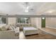 Cozy living room featuring a large sectional sofa, ceiling fan, and natural light at 811 Gatehouse Dr, Winter Springs, FL 32708