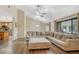 Open living room with a sectional sofa, hardwood floors, and view into the kitchen at 811 Gatehouse Dr, Winter Springs, FL 32708