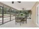 Inviting screened-in patio featuring tiled floors and a ceiling fan for comfortable outdoor enjoyment at 811 Gatehouse Dr, Winter Springs, FL 32708