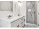 Modern bathroom features double sinks, white cabinets, gold hardware, and a marble shower at 833 S Hancock Dr, Deltona, FL 32725