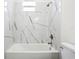 Bright bathroom features a marble-style tiled shower and a modern bathtub at 833 S Hancock Dr, Deltona, FL 32725