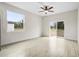 This bedroom is bright and spacious, with a ceiling fan, wood floors, and a large window at 833 S Hancock Dr, Deltona, FL 32725