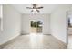 Bright bedroom features wood floors, a ceiling fan, and sliding glass door to the backyard at 833 S Hancock Dr, Deltona, FL 32725