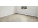 Bedroom with modern wood-look flooring and a bright window view at 833 S Hancock Dr, Deltona, FL 32725