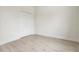 Bright bedroom with modern wood-look flooring and a closet with bi-fold doors at 833 S Hancock Dr, Deltona, FL 32725