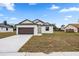 Charming single-story home with a well-maintained lawn and a two-car garage at 833 S Hancock Dr, Deltona, FL 32725