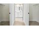 Hallway view into a modern bathroom with double vanities and marble shower at 833 S Hancock Dr, Deltona, FL 32725