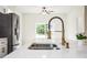 Close-up of a modern kitchen island featuring quartz countertops and a stylish sink and faucet at 833 S Hancock Dr, Deltona, FL 32725