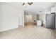 Open floor plan with wood floors, ceiling fan, and a modern kitchen with stainless steel appliances at 833 S Hancock Dr, Deltona, FL 32725
