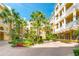 Beautiful apartment building exterior with a courtyard featuring tropical landscaping and a fountain at 860 N Orange Ave # 444, Orlando, FL 32801