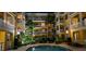 Night shot of community pool with illuminated tropical landscaping in the courtyard of a multi-story condominium at 860 N Orange Ave # 444, Orlando, FL 32801