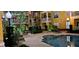 Beautifully landscaped community pool with elegant lighting and comfortable lounge chairs at 860 N Orange Ave # 444, Orlando, FL 32801