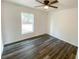 Bright bedroom featuring hardwood floors, fresh paint, base molding and a ceiling fan at 1 Pine Radial Trl, Ocala, FL 34472