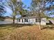 Well-maintained backyard featuring a white fence line and beautiful trees providing natural shade and privacy at 1004 Puget Ln, Kissimmee, FL 34759