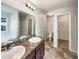 Spacious bathroom featuring double sinks, a large mirror, and a separate shower and tub at 1004 Puget Ln, Kissimmee, FL 34759