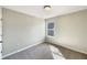 Neutral bedroom with carpet, featuring ample natural light through a window, creating a serene and inviting space at 1004 Puget Ln, Kissimmee, FL 34759