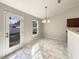 Bright dining area with a modern light fixture and direct access to the backyard, ideal for indoor-outdoor dining at 1004 Puget Ln, Kissimmee, FL 34759