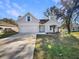 Charming home featuring a two-car garage, neat landscaping, and a welcoming front entrance at 1004 Puget Ln, Kissimmee, FL 34759