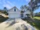 Charming home featuring a two-car garage, neat landscaping, and a welcoming front entrance at 1004 Puget Ln, Kissimmee, FL 34759