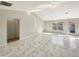 Bright and open living room with sleek marble floors, neutral walls, and ample natural light at 1004 Puget Ln, Kissimmee, FL 34759